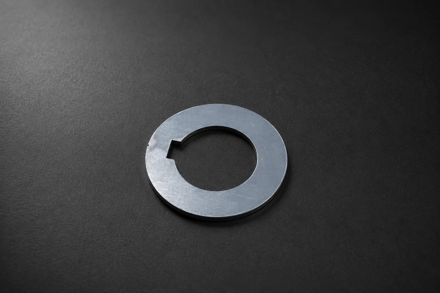 Detailed laser-cut carbon steel spacer with key slot
